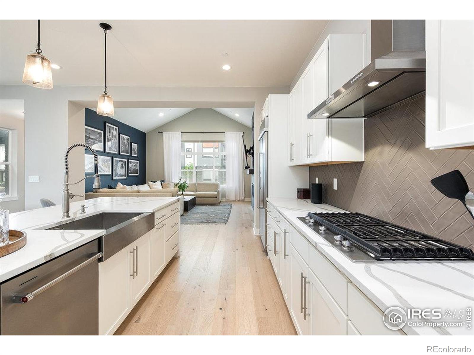 730 Promenade Drive Superior, CO 80027 - Photo 12 of 50 a kitchen with stainless steel appliances a sink a stove top oven a counter space and cabinets