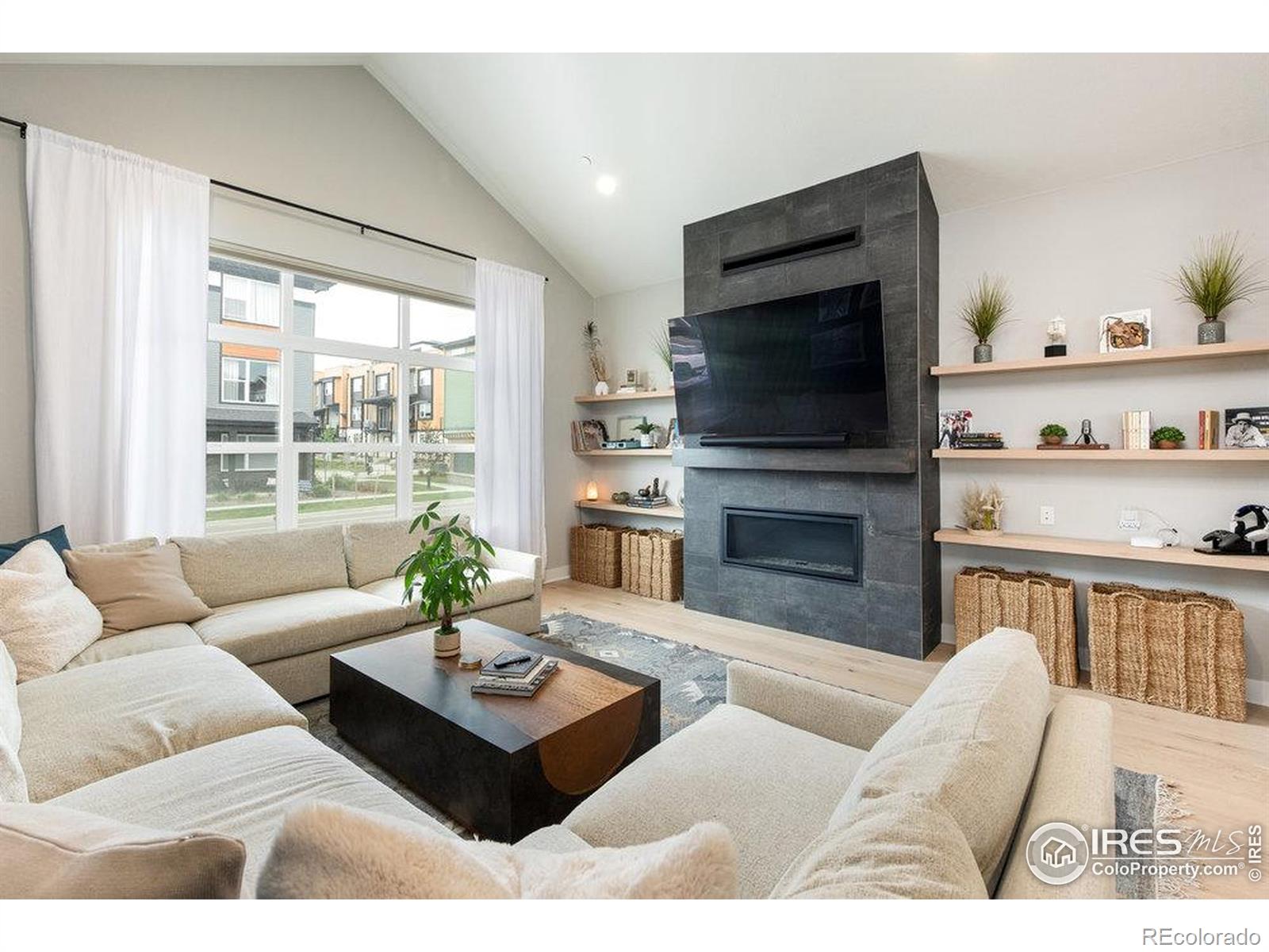 730 Promenade Drive Superior, CO 80027 - Photo 15 of 50 a living room with furniture a flat screen tv and a fireplace