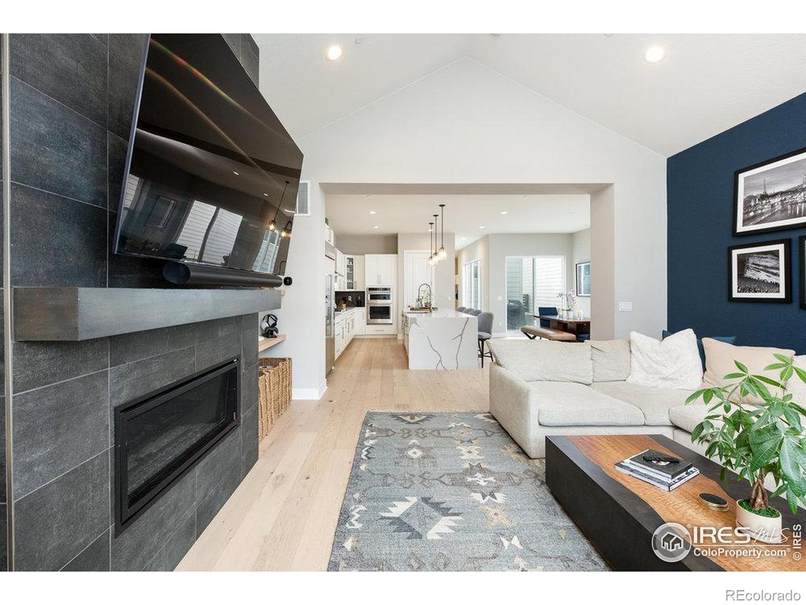 730 Promenade Drive Superior, CO 80027 - Photo 17 of 50 a living room with furniture a fireplace and a flat screen tv