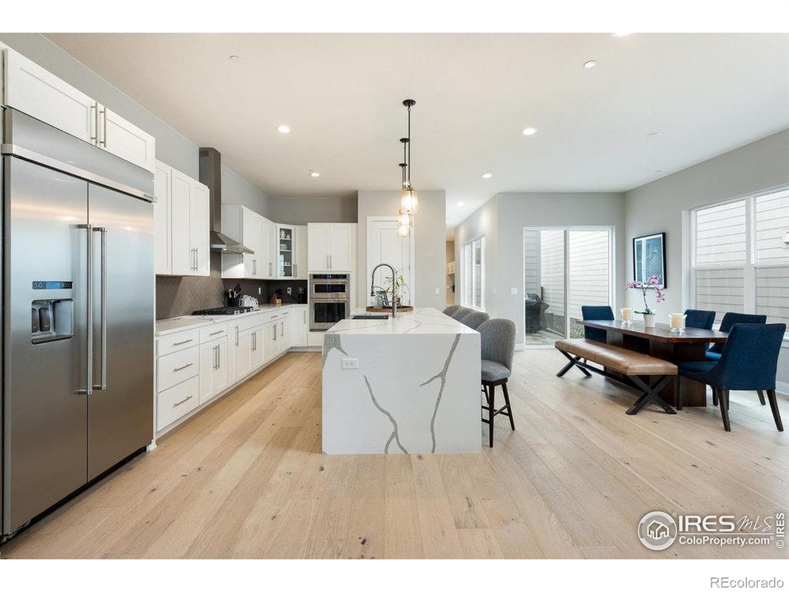 730 Promenade Drive Superior, CO 80027 - Photo 18 of 50 a living room with stainless steel appliances kitchen island granite countertop furniture wooden floor and a view of kitchen