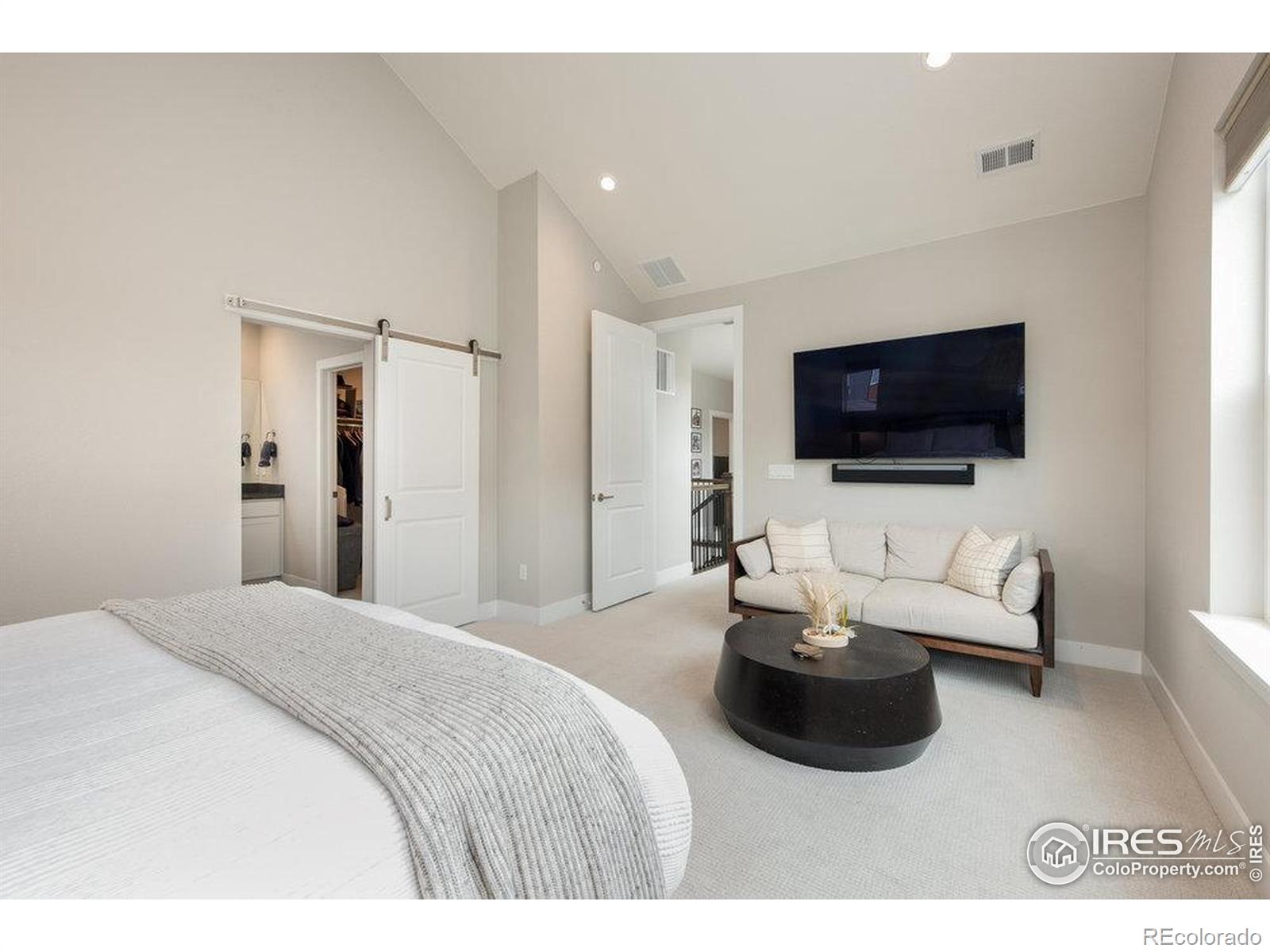 730 Promenade Drive Superior, CO 80027 - Photo 28 of 50 a bedroom with a bed and a flat screen tv