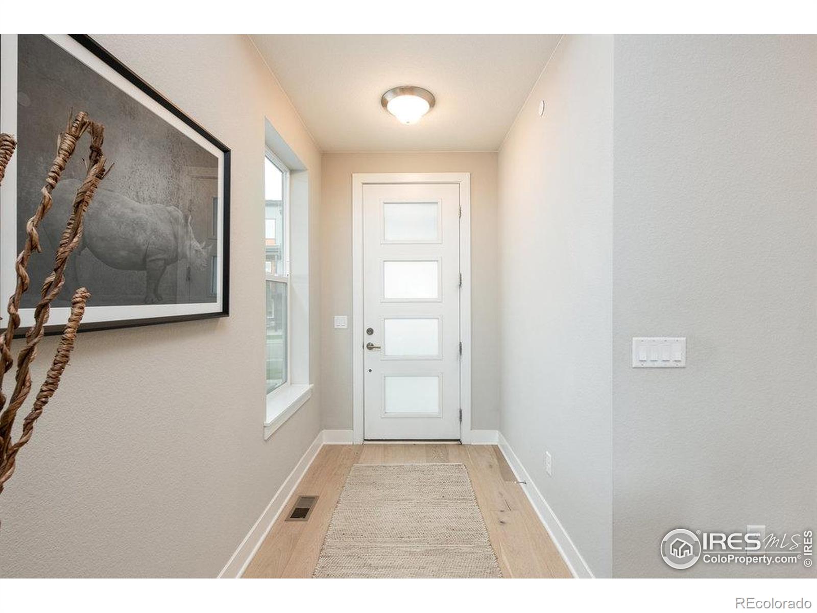 730 Promenade Drive Superior, CO 80027 - Photo 6 of 50 a view of a hallway with wooden floor and a bathroom
