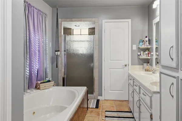 a bathroom with a granite countertop sink a toilet and a mirror
