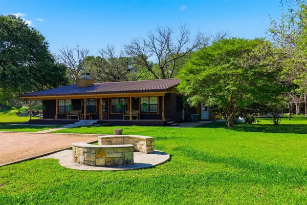 a front view of a house with a yard table and chairs