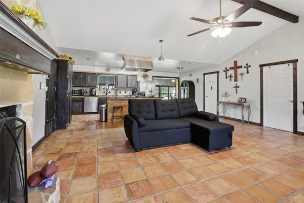 a living room with stainless steel appliances kitchen island granite countertop furniture and a kitchen view