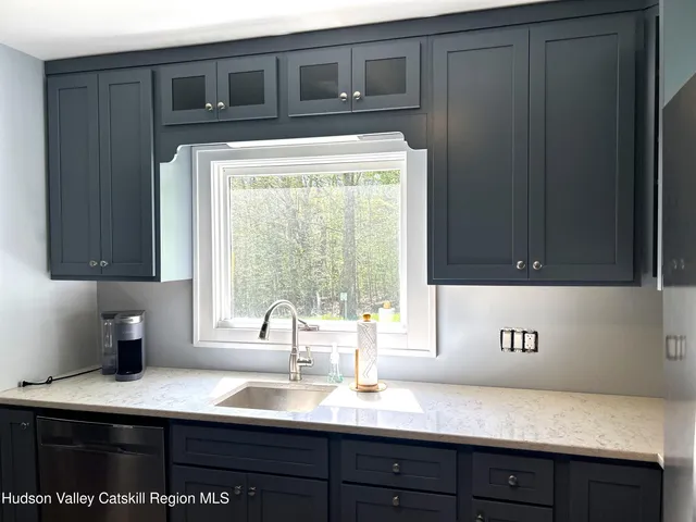 a stove top oven sitting inside of a kitchen