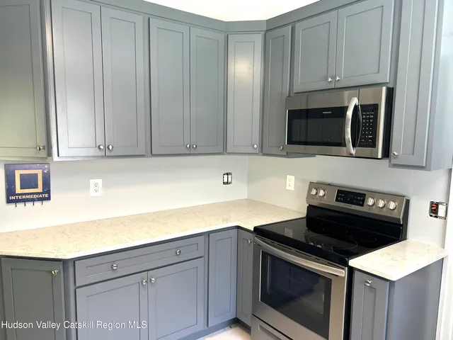 a kitchen with a sink stove and microwave