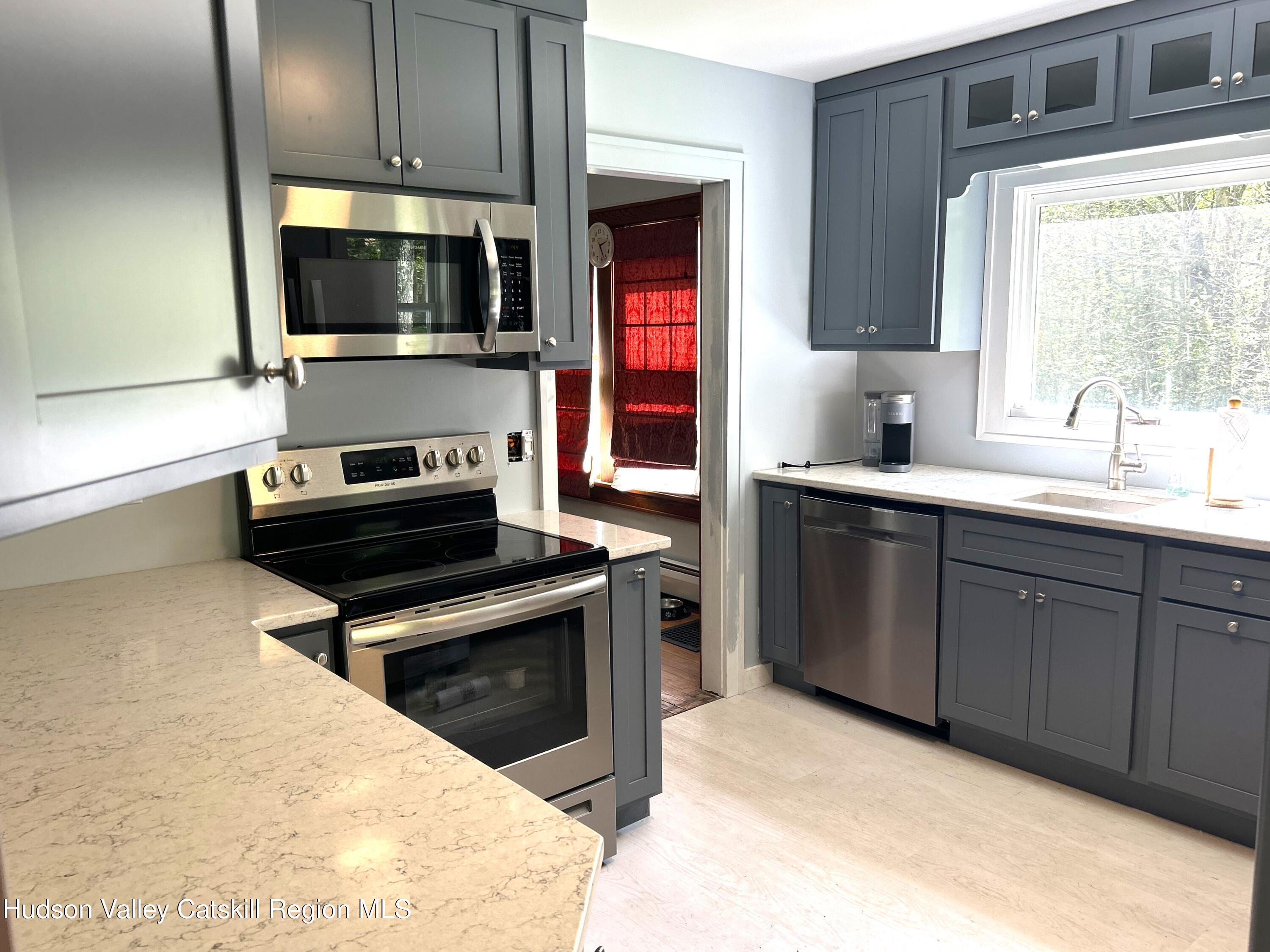 169 Rt 4 Prattsville, NY 12468 - Photo 18 of 35 a kitchen with a sink stove and microwave