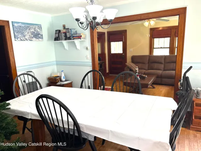 a view of a dining room with furniture and chandelier