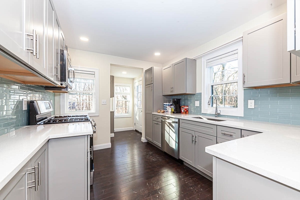 48 Caldwell Road, Unit 48 Waltham, MA 02453 - Photo 13 of 38 a large kitchen with stainless steel appliances granite countertop a stove a sink dishwasher and a refrigerator
