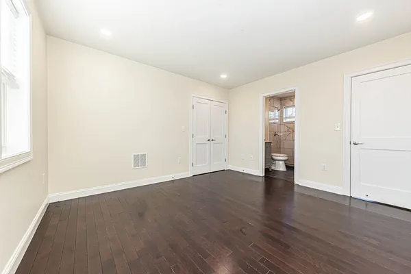 an empty room with wooden floor