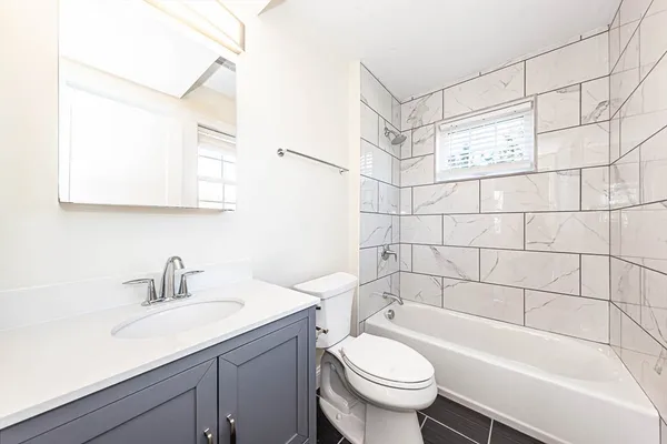 a bathroom with a sink a toilet and bathtub