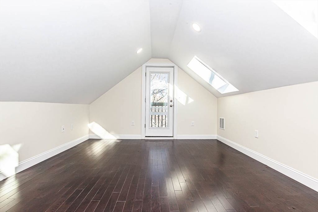 48 Caldwell Road, Unit 48 Waltham, MA 02453 - Photo 29 of 38 a view of an empty room with wooden floor and a window
