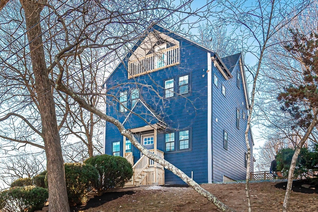 48 Caldwell Road, Unit 48 Waltham, MA 02453 - Photo 3 of 38 a front view of a house with a yard and garage