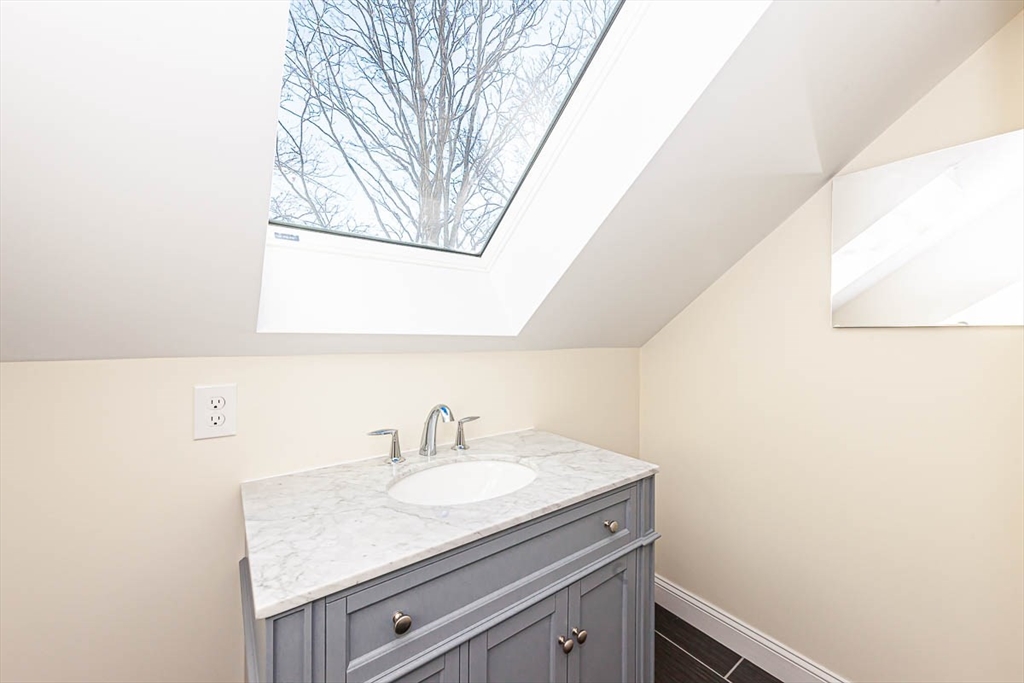48 Caldwell Road, Unit 48 Waltham, MA 02453 - Photo 35 of 38 a bathroom with a sink and a mirror