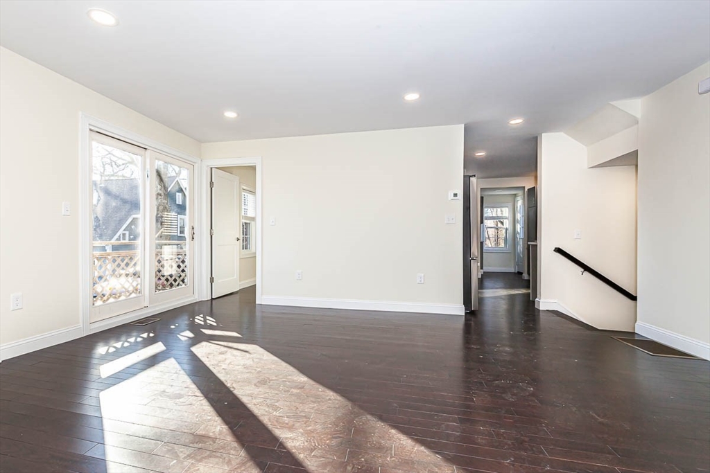 48 Caldwell Road, Unit 48 Waltham, MA 02453 - Photo 6 of 38 a view of an empty room with wooden floor and a window