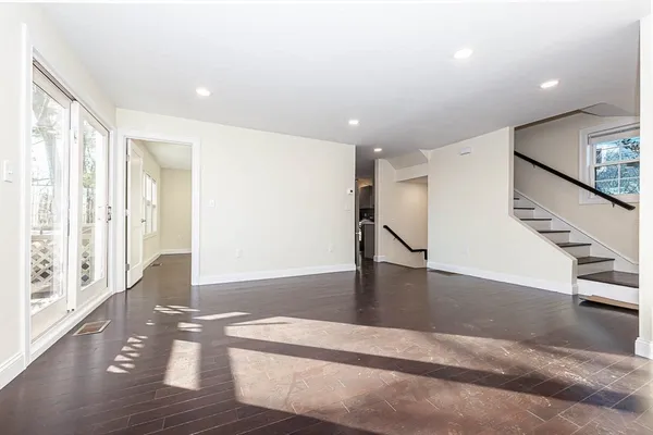 a view of an entryway with wooden floor