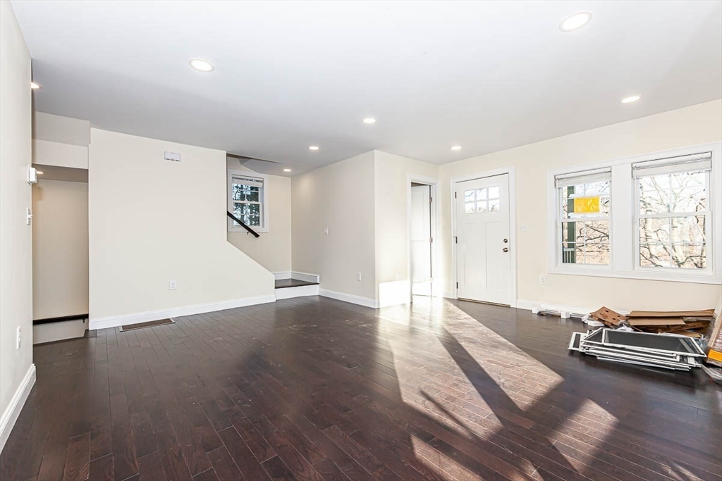 48 Caldwell Road, Unit 48 Waltham, MA 02453 - Photo 8 of 38 a view of a livingroom with wooden floor and couch