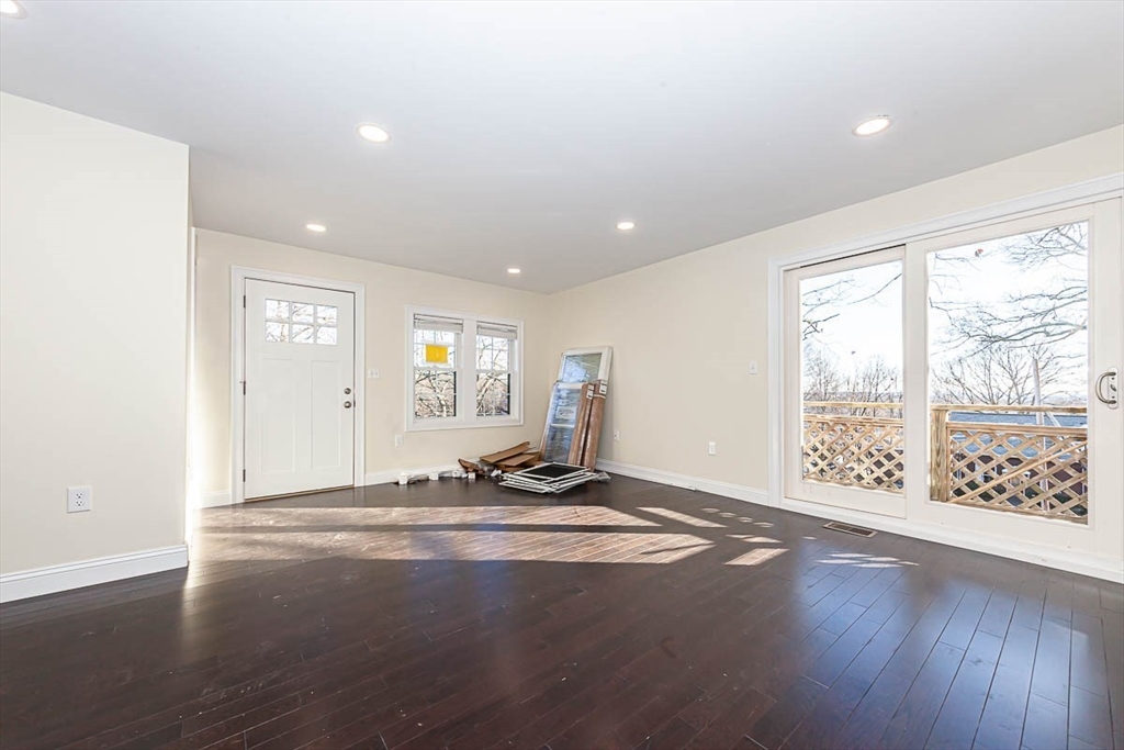 48 Caldwell Road, Unit 48 Waltham, MA 02453 - Photo 9 of 38 a view of an empty room with wooden floor and a window