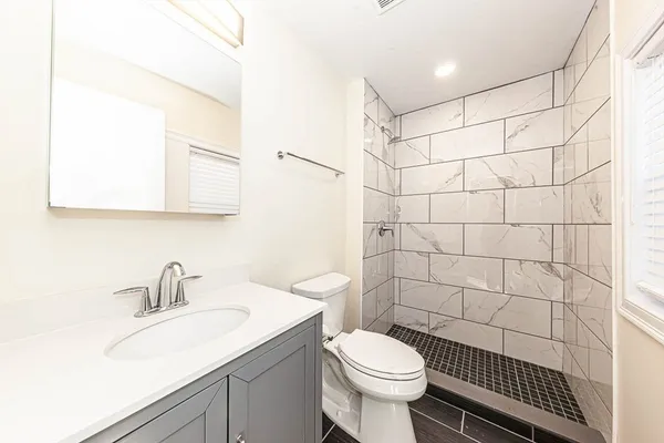 a bathroom with a sink toilet and shower