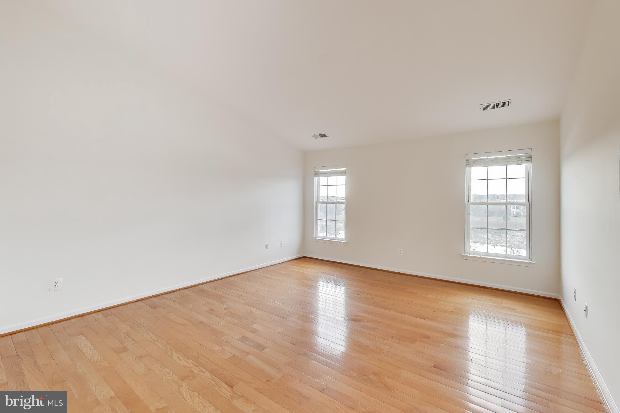 42759 Locklear Terrace Chantilly, VA 20152 - Photo 19 of 38 an empty room with wooden floor and windows