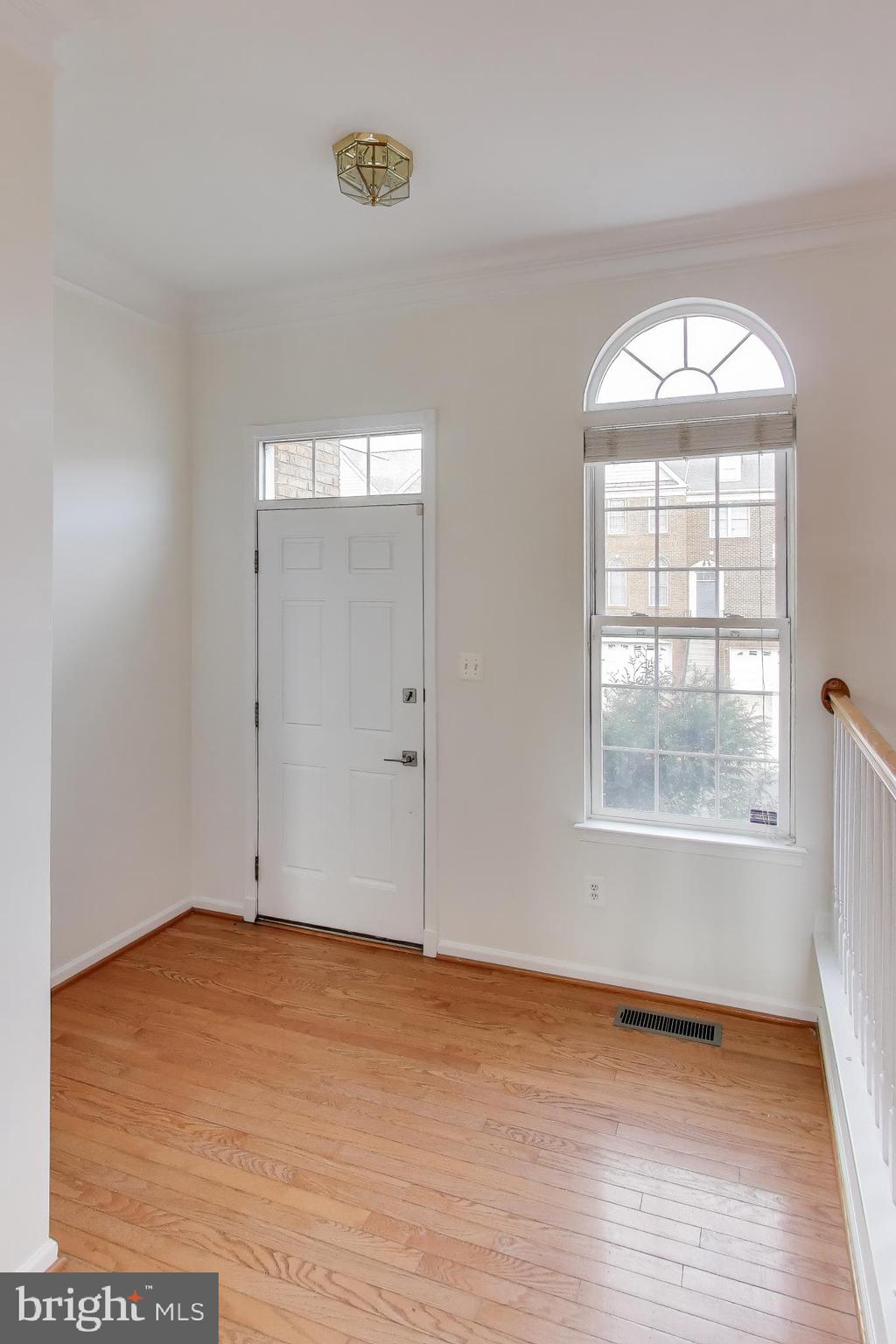 42759 Locklear Terrace Chantilly, VA 20152 - Photo 2 of 38 an empty room with wooden floor and windows