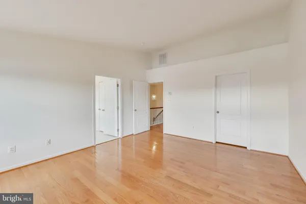 a view of an empty room and wooden floor
