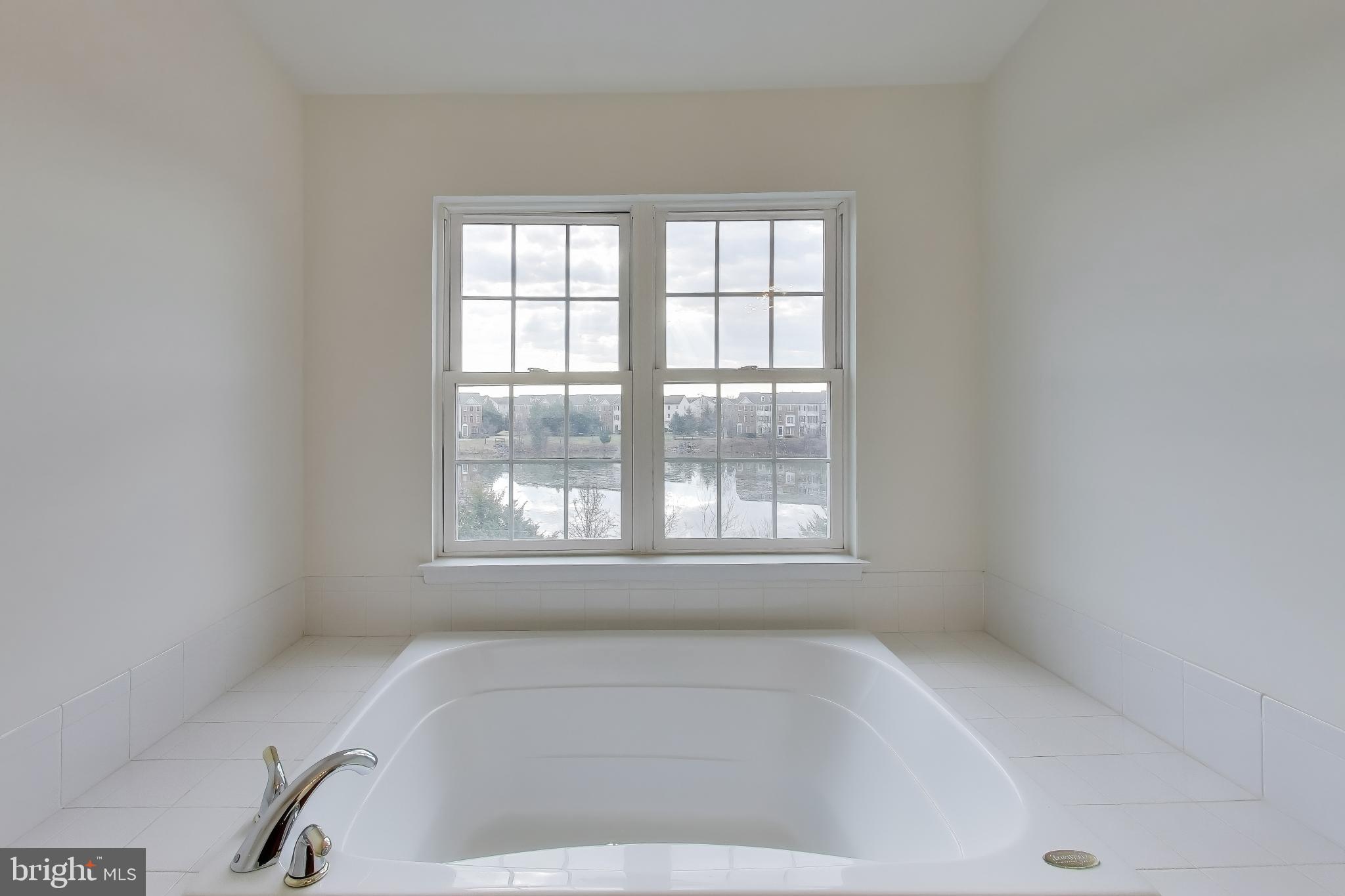 42759 Locklear Terrace Chantilly, VA 20152 - Photo 23 of 38 a white bath tub sitting in a bathroom next to a window