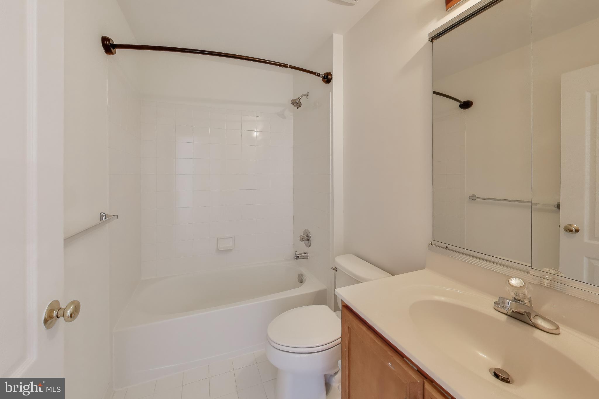 42759 Locklear Terrace Chantilly, VA 20152 - Photo 29 of 38 a bathroom with a sink toilet and shower