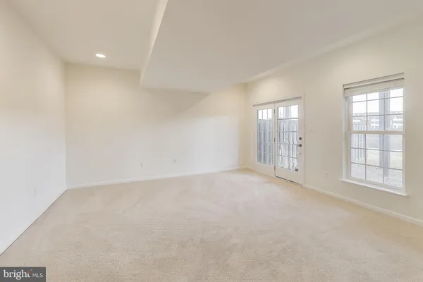 an empty room with windows and closet