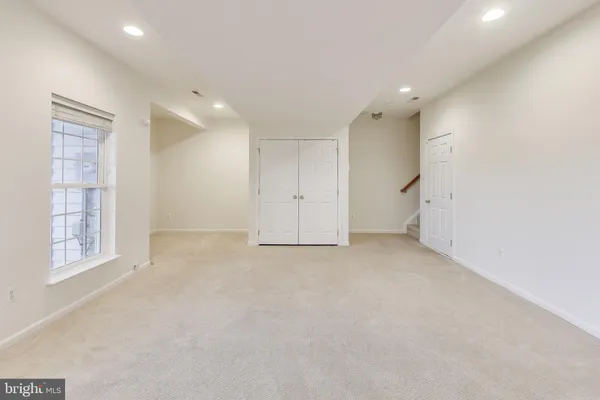 an empty room with windows and closet