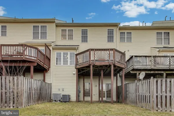 a view of a house with wooden deck and furniture