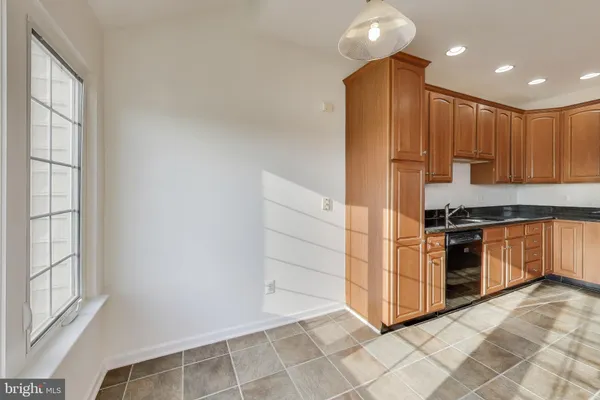a kitchen with stainless steel appliances a refrigerator and a stove top oven