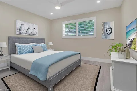 a bedroom with a bed and a potted plant