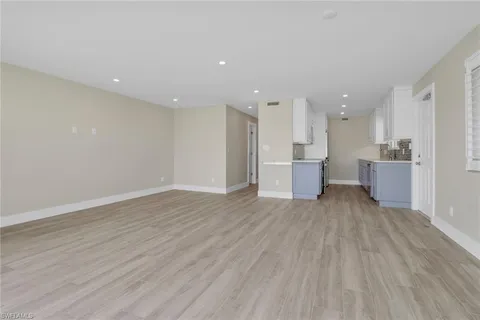 a view of a kitchen with a sink and wooden floor