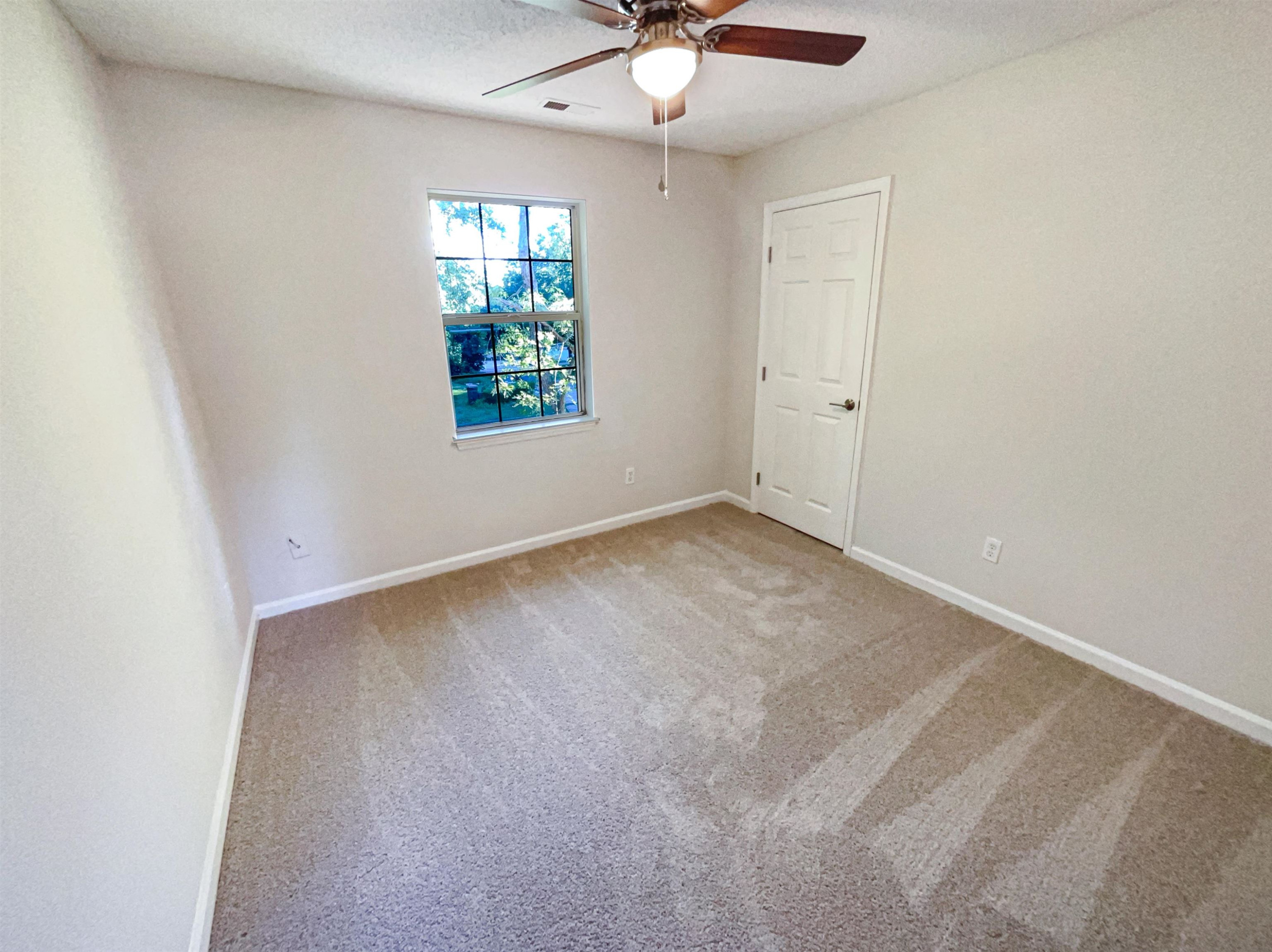 7416 Wisconsin Court Raleigh, NC 27615 - Photo 13 of 17 an empty room with windows and fan