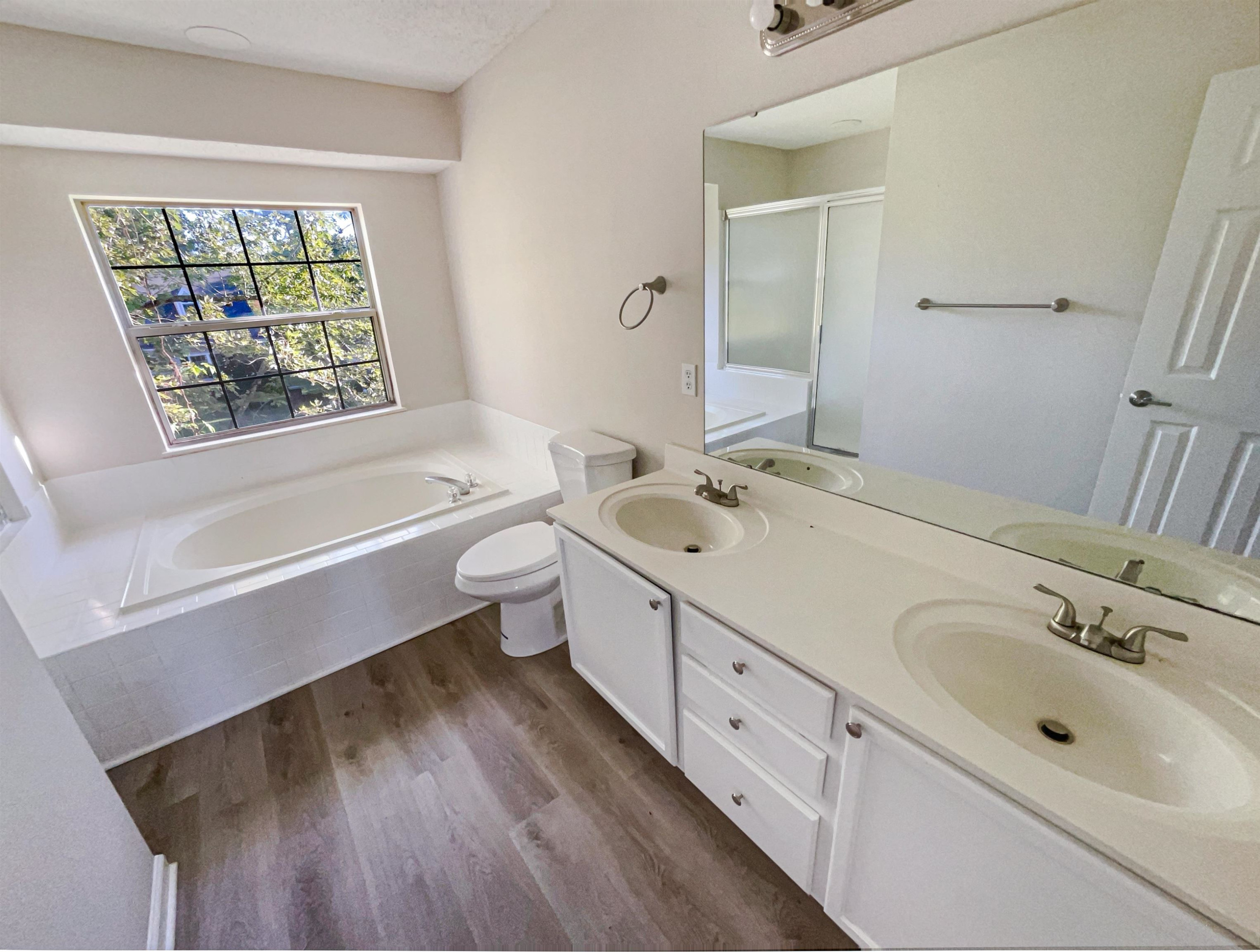 7416 Wisconsin Court Raleigh, NC 27615 - Photo 15 of 17 a bathroom with a bathtub sink and a window
