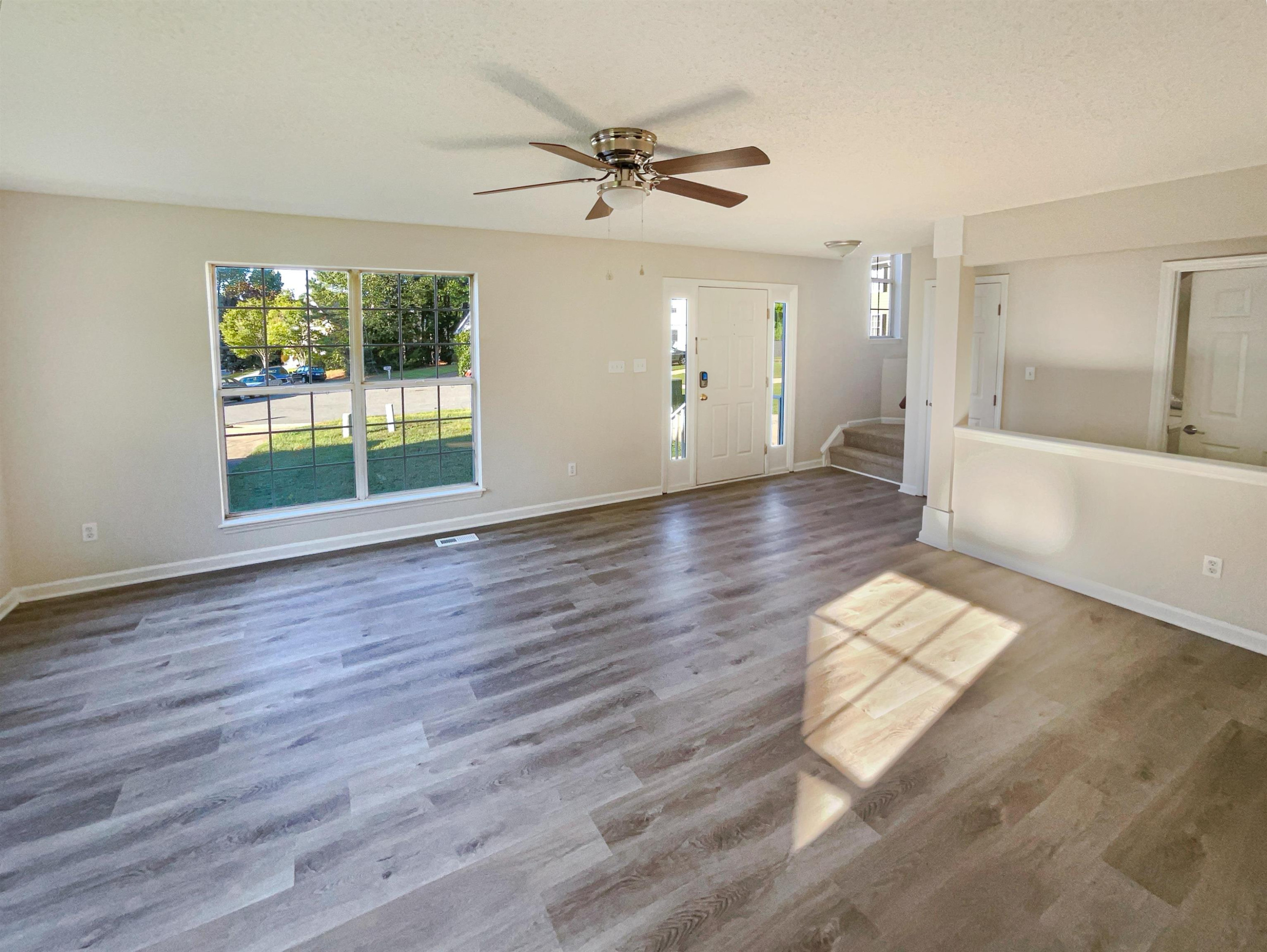 7416 Wisconsin Court Raleigh, NC 27615 - Photo 3 of 17 a view of an empty room with a window and wooden floor