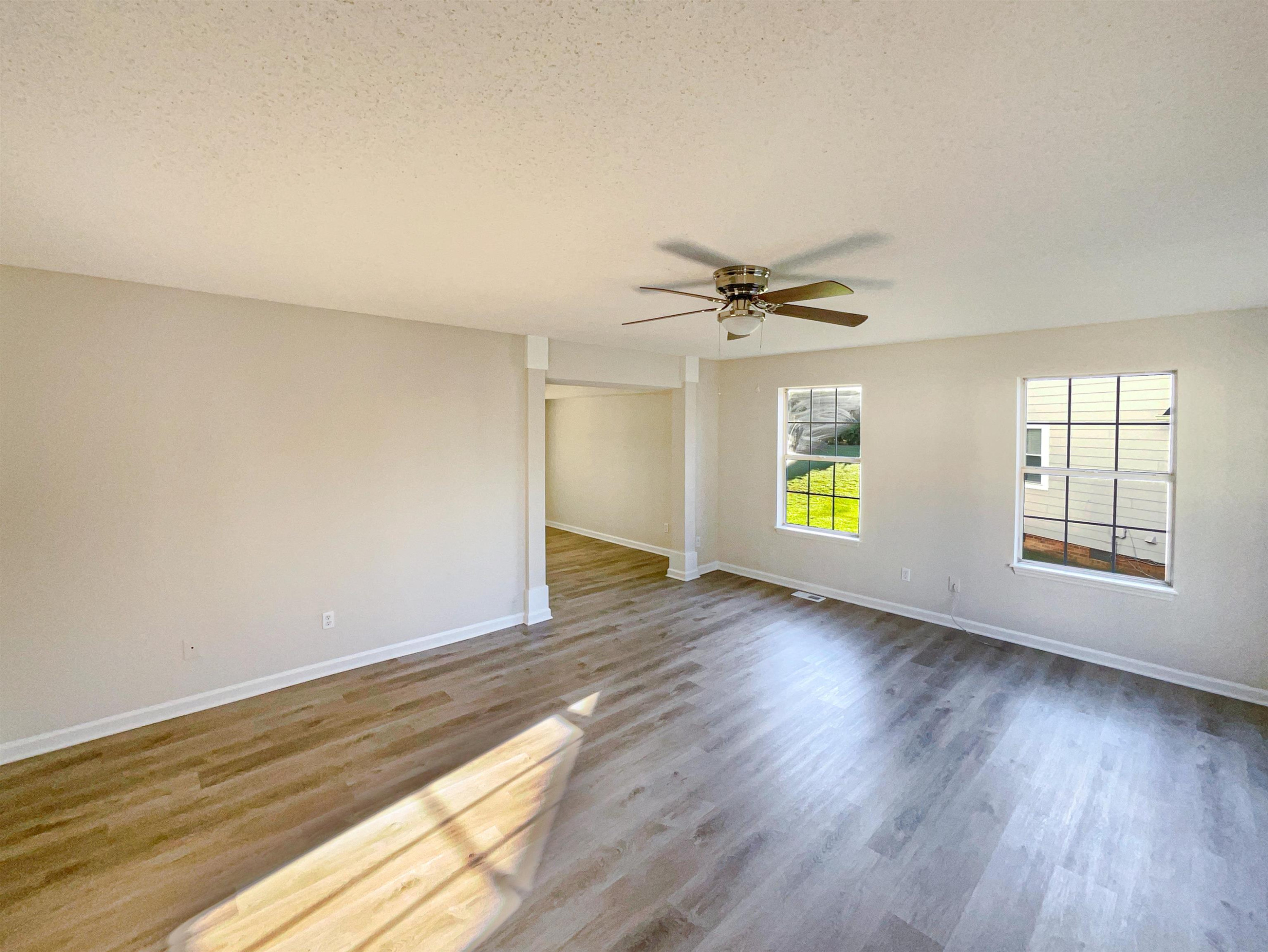 7416 Wisconsin Court Raleigh, NC 27615 - Photo 7 of 17 a view of an empty room with a window and wooden floor