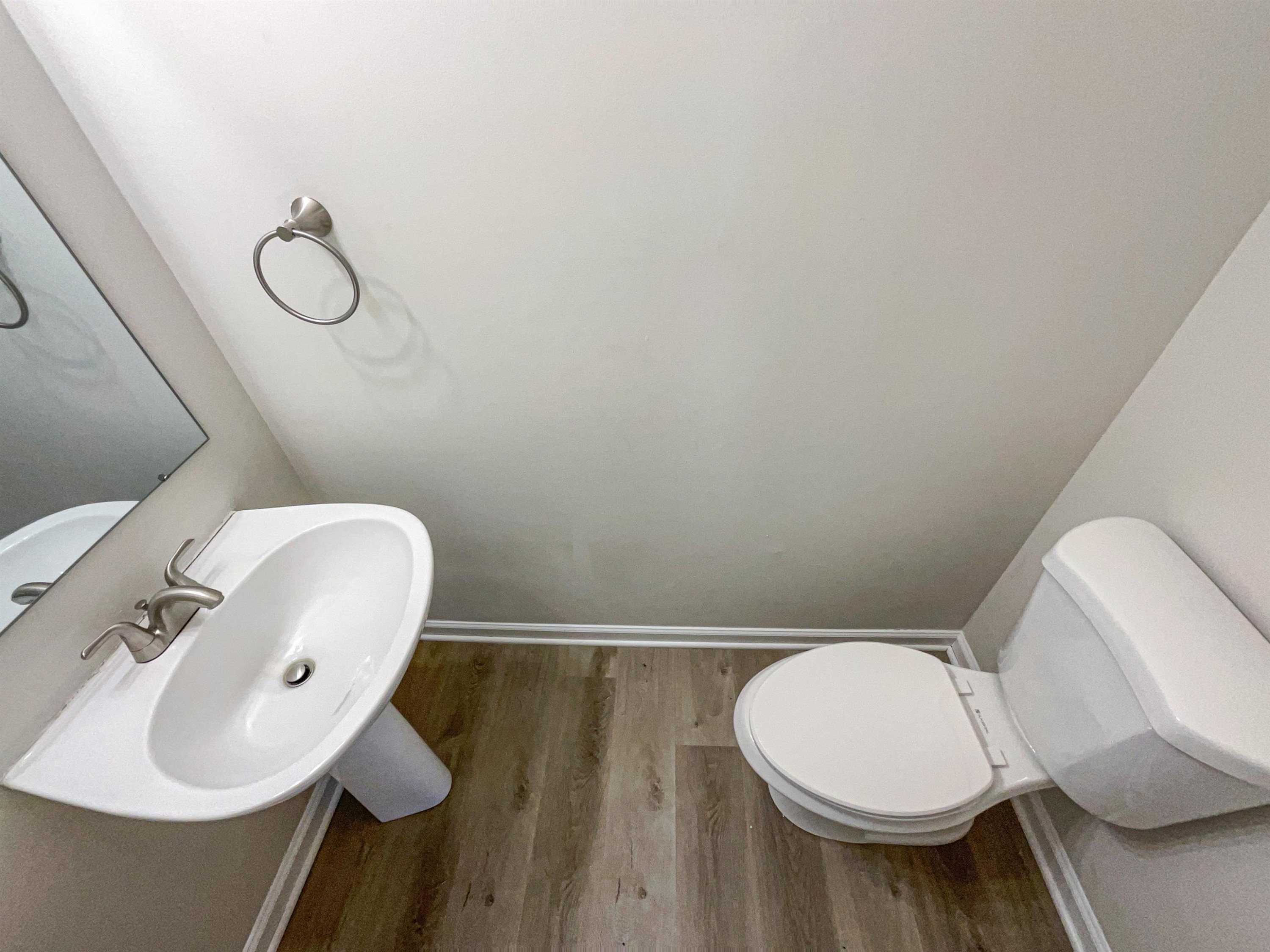 7416 Wisconsin Court Raleigh, NC 27615 - Photo 10 of 17 a bathroom with a toilet sink and mirror