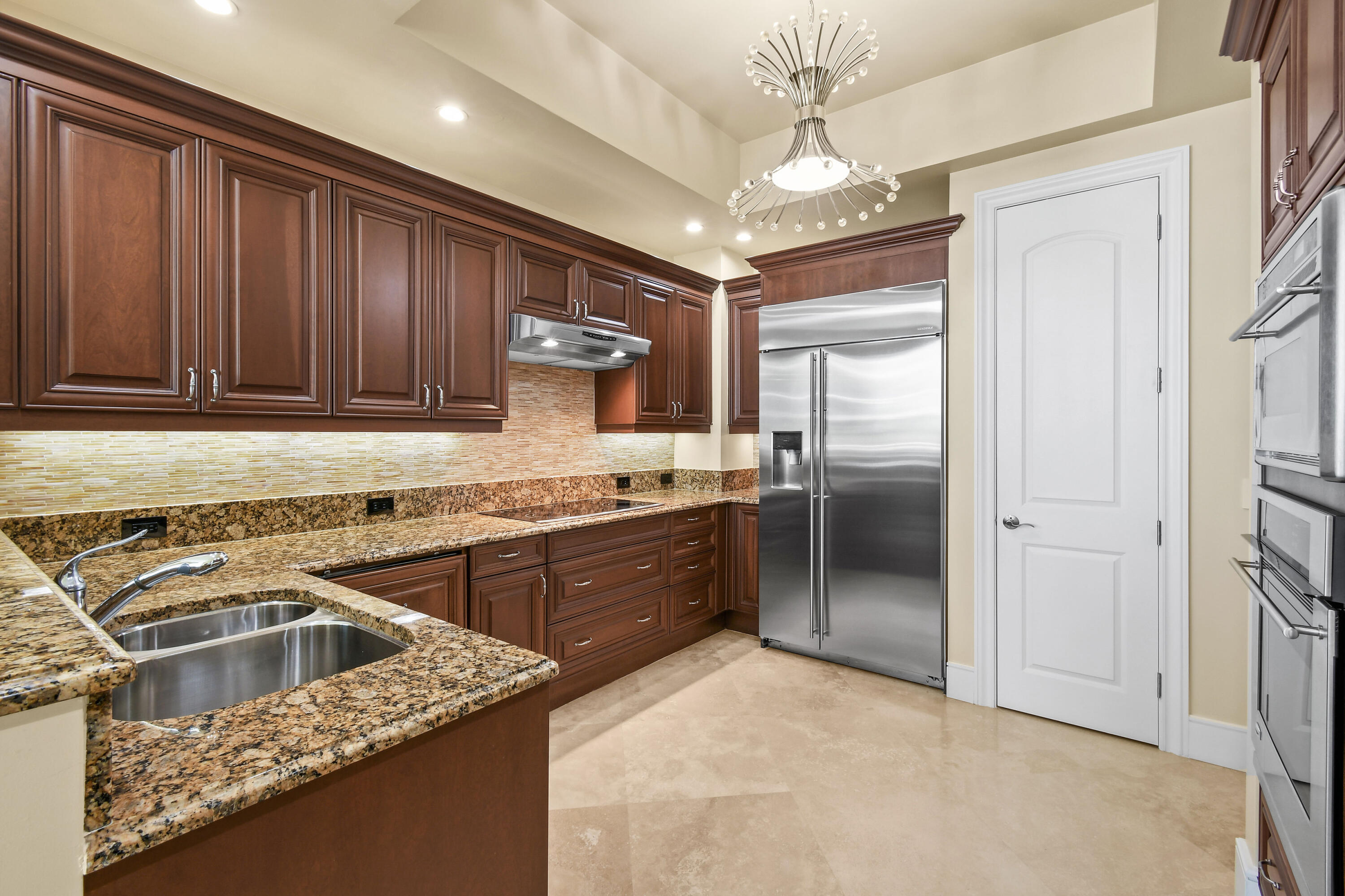 4600 North Ocean Drive, Unit 406 Singer Island, FL 33404 - Photo 25 of 106 a kitchen with kitchen island granite countertop a stove sink and refrigerator