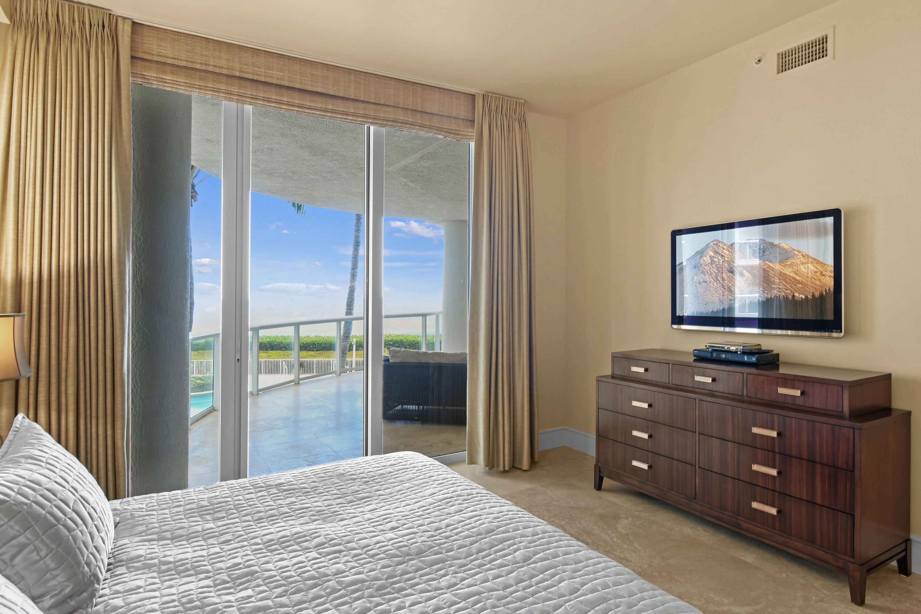 4600 North Ocean Drive, Unit 406 Singer Island, FL 33404 - Photo 42 of 106 a bedroom with a bed and a flat screen tv