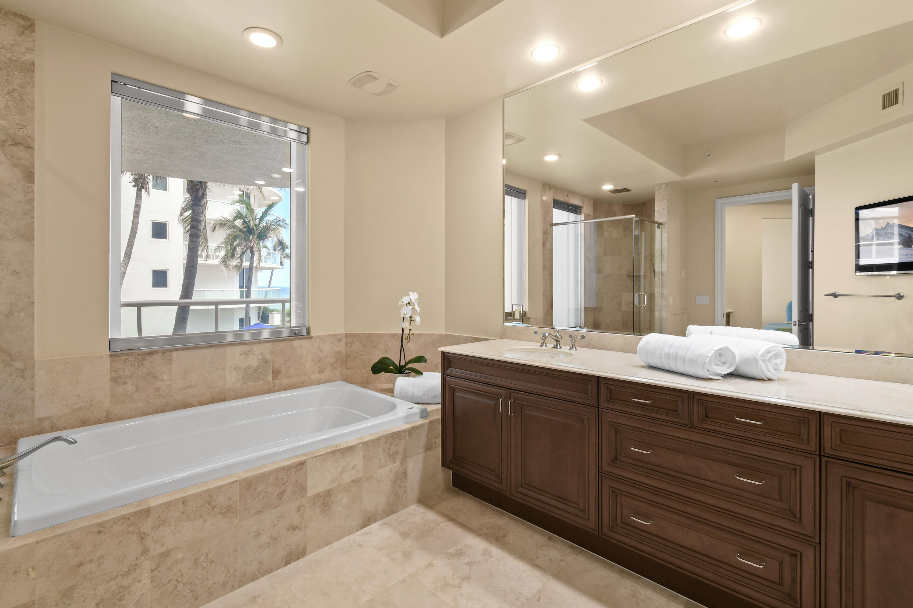 4600 North Ocean Drive, Unit 406 Singer Island, FL 33404 - Photo 47 of 106 a spacious bathroom with a tub sink double vanity and mirror
