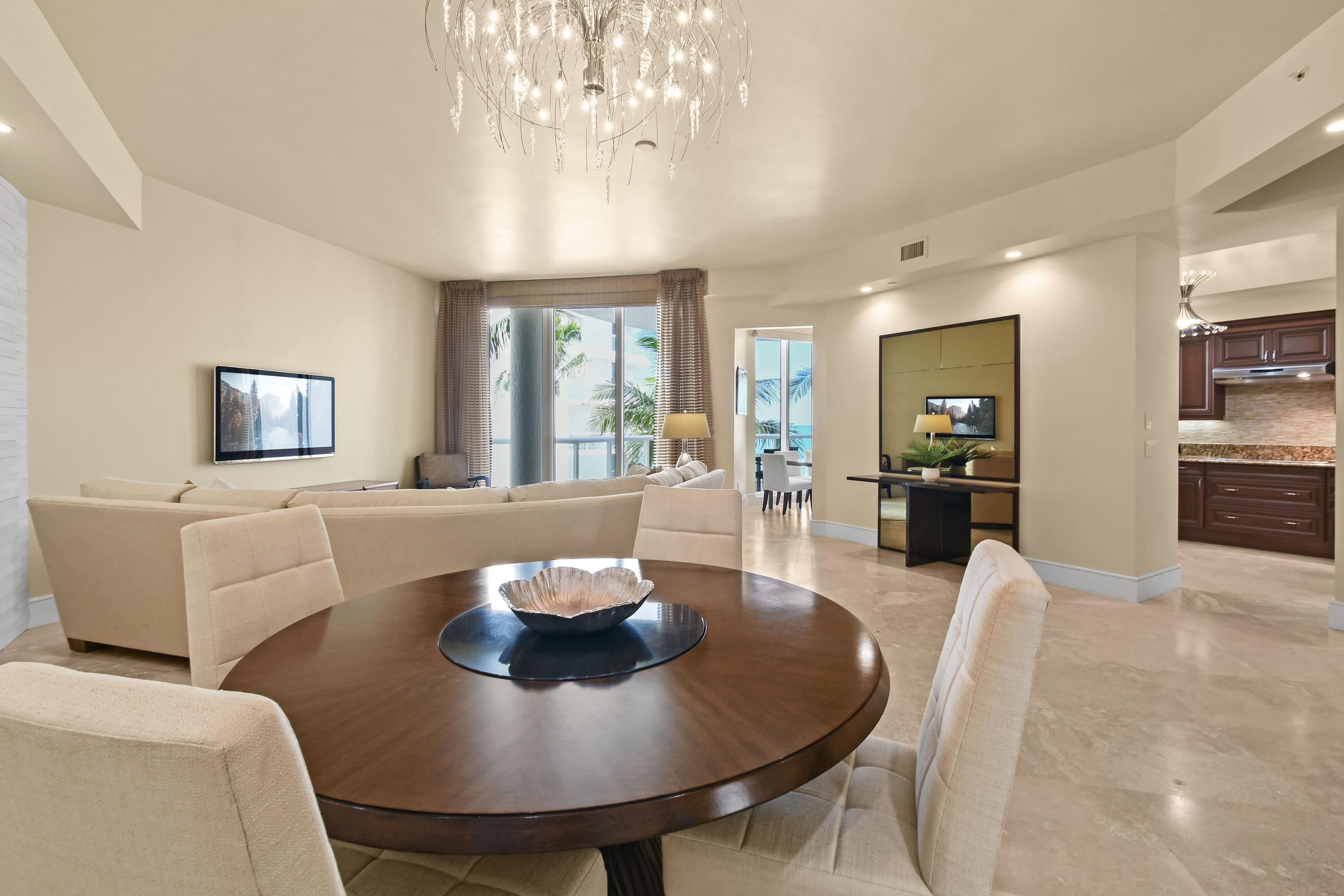 4600 North Ocean Drive, Unit 406 Singer Island, FL 33404 - Photo 5 of 106 a living room with furniture a chandelier and a dining table