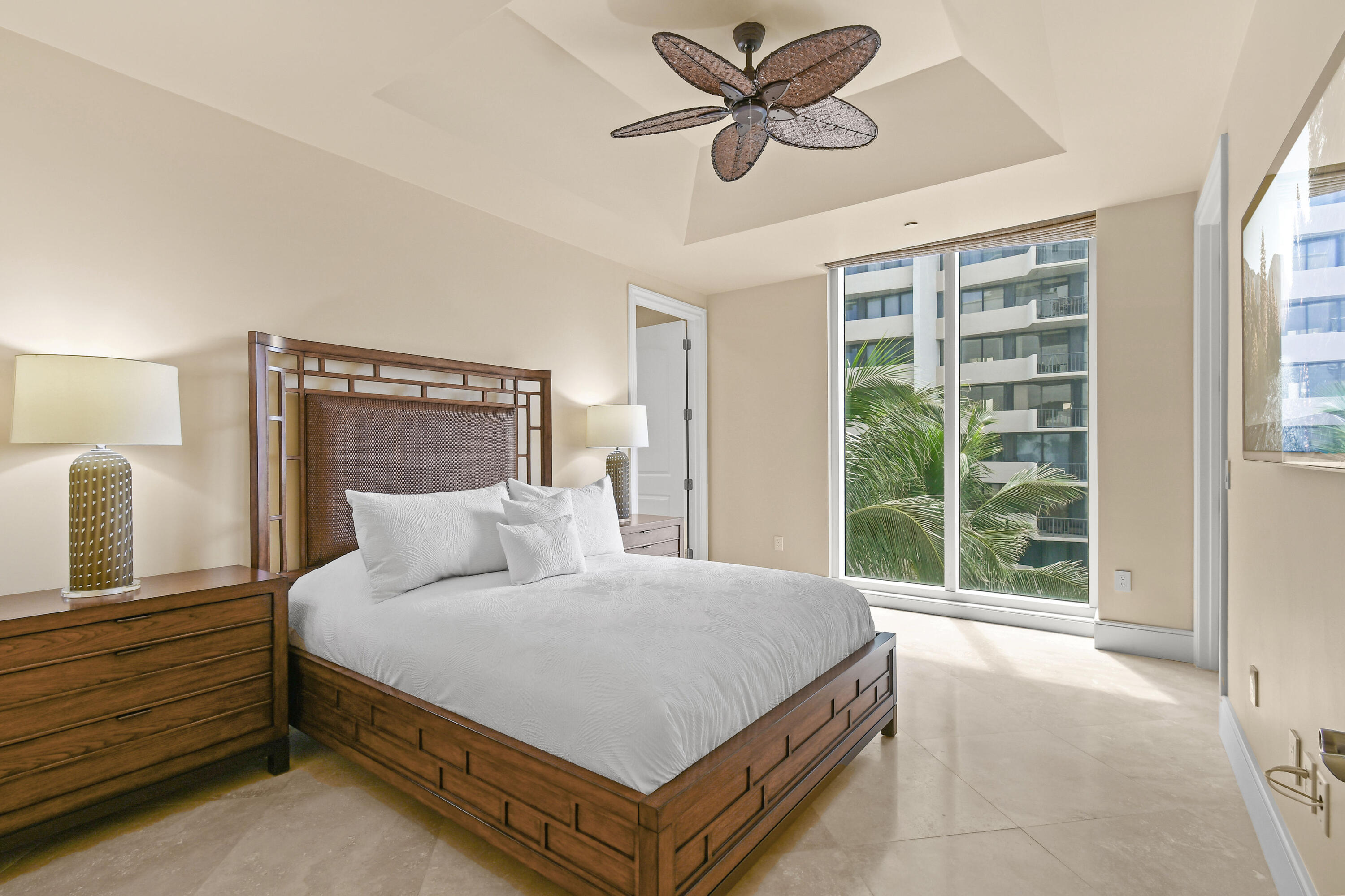 4600 North Ocean Drive, Unit 406 Singer Island, FL 33404 - Photo 55 of 106 a bedroom with a large bed and a chandelier