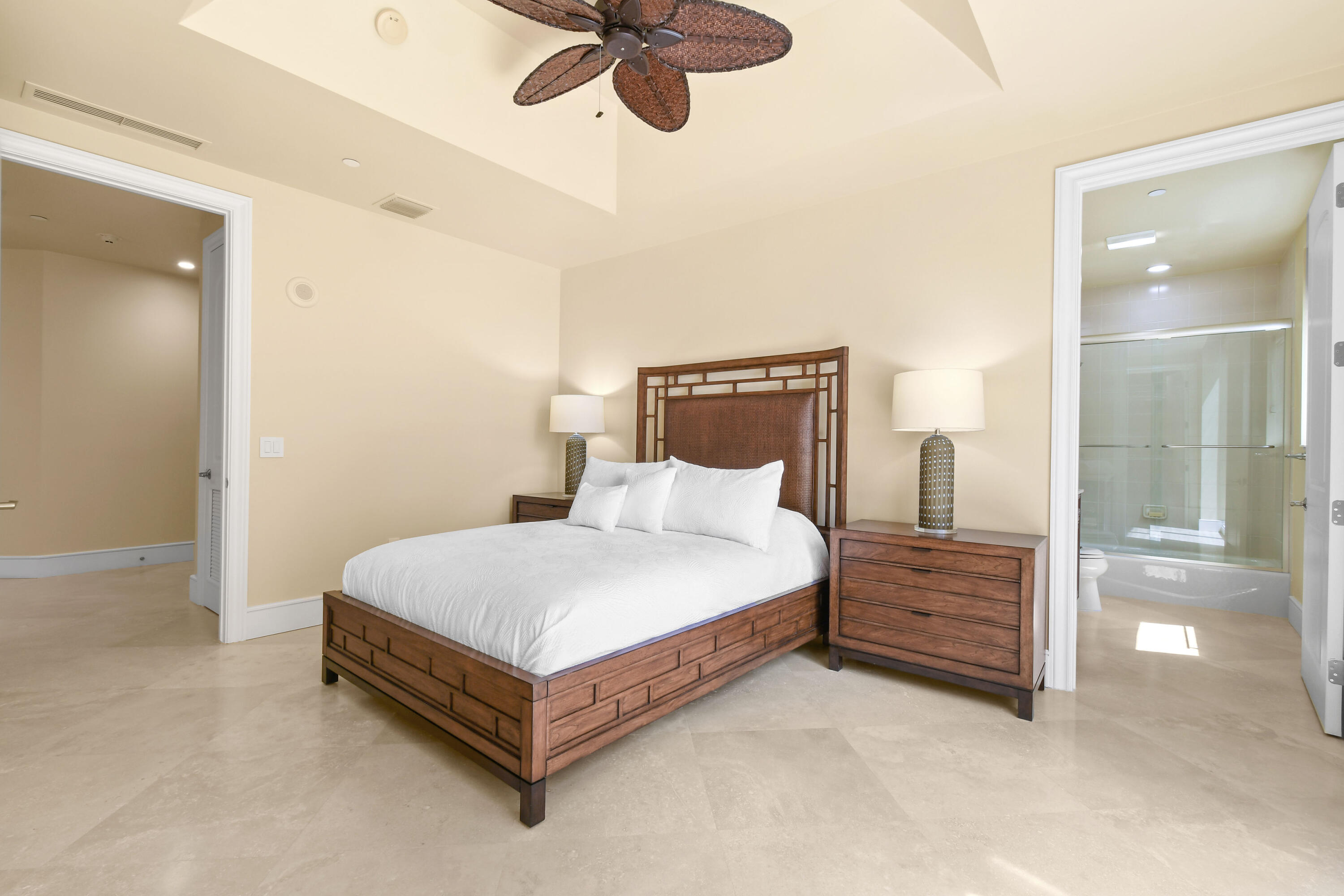 4600 North Ocean Drive, Unit 406 Singer Island, FL 33404 - Photo 57 of 106 a spacious bedroom with a bed and painting on the wall