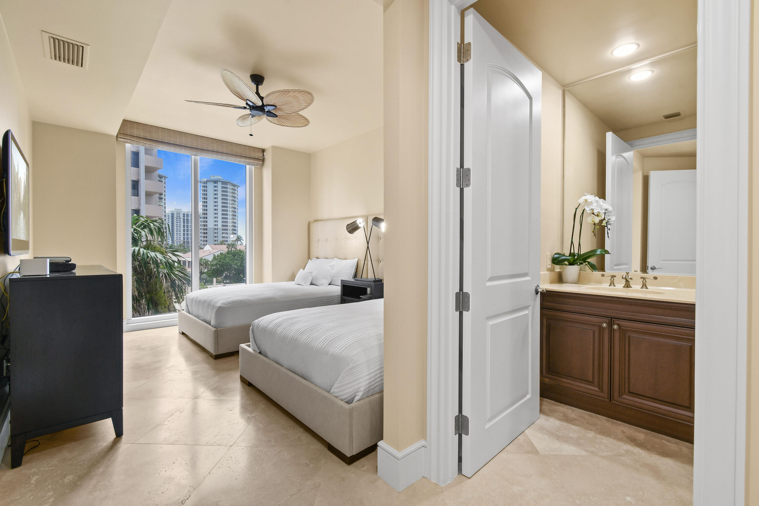 4600 North Ocean Drive, Unit 406 Singer Island, FL 33404 - Photo 62 of 106 a bedroom with a large bed and a chandelier