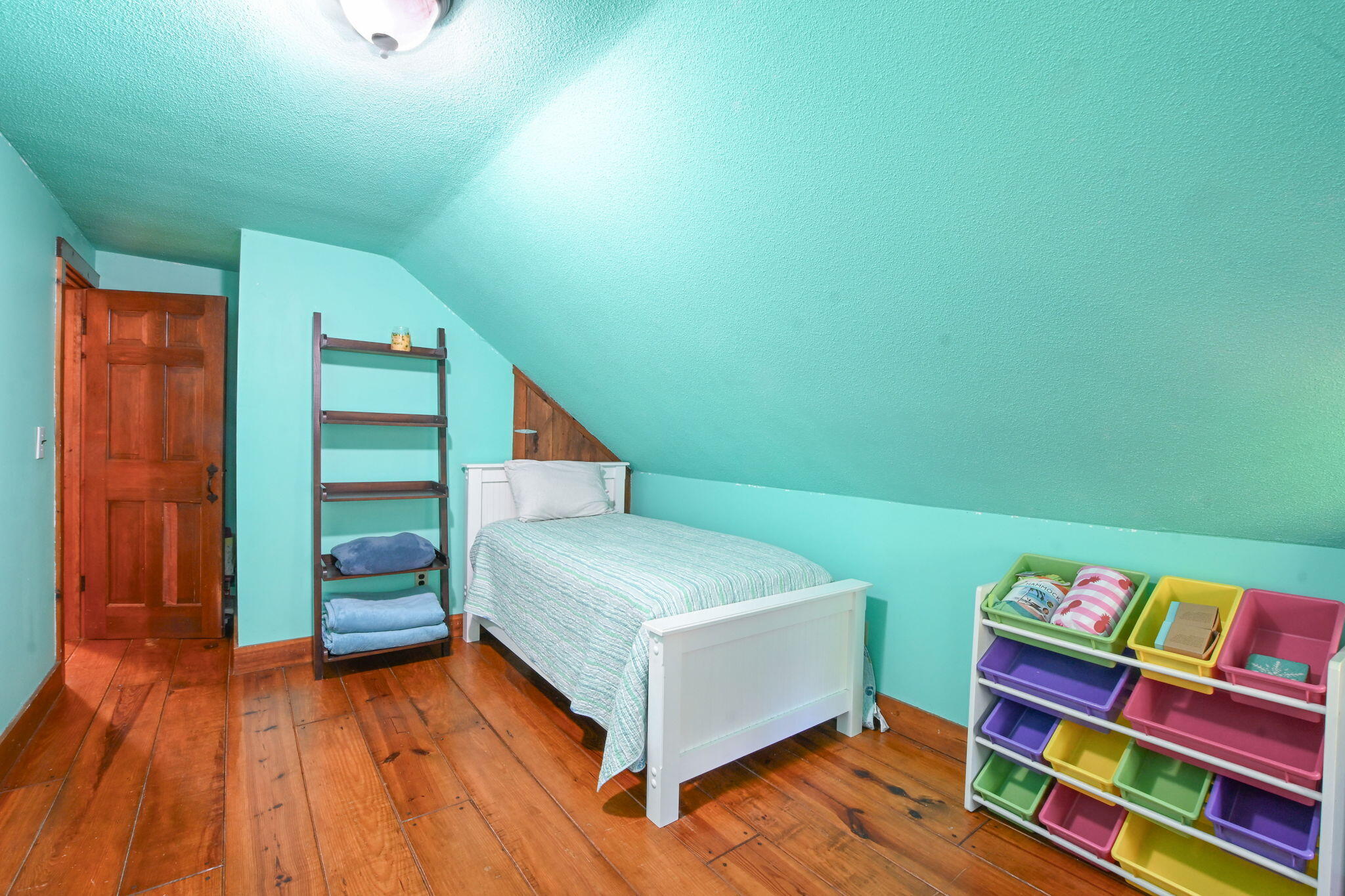 23 Old Fields Road Sandwich, MA 02563 - Photo 22 of 26 a bedroom with a bed and a wooden floor
