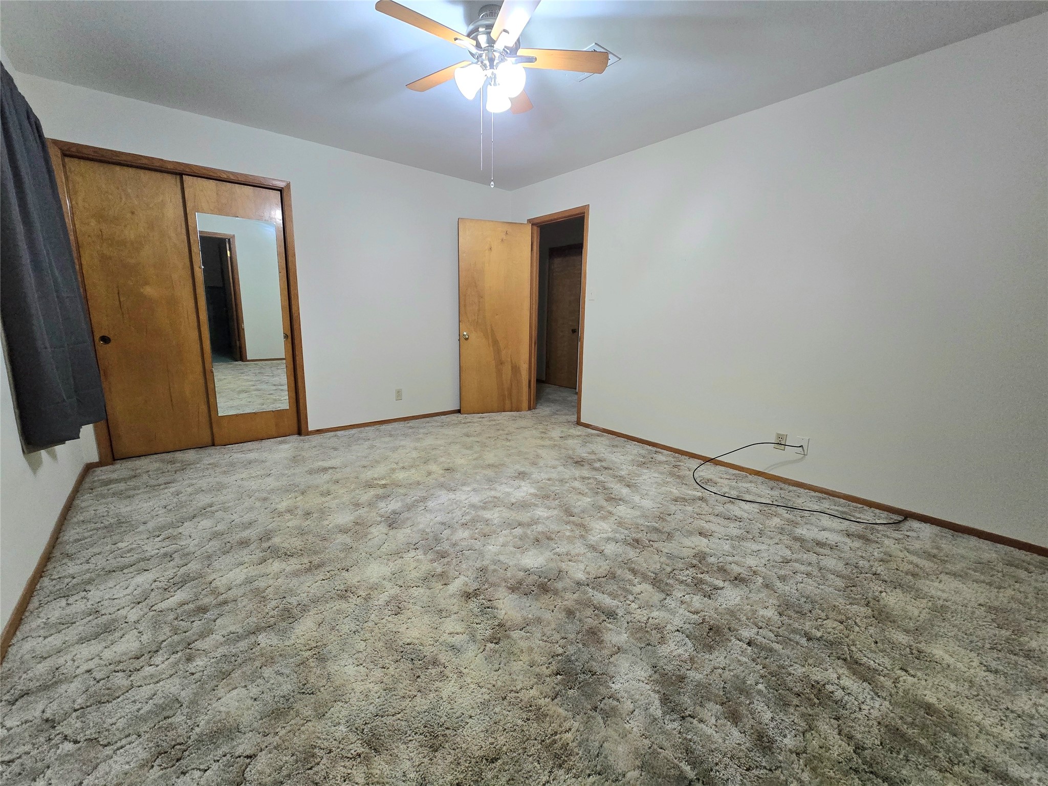 607 South Main Street Dayton, TX 77535 - Photo 20 of 39 a view of an empty room with wooden floor and a ceiling fan