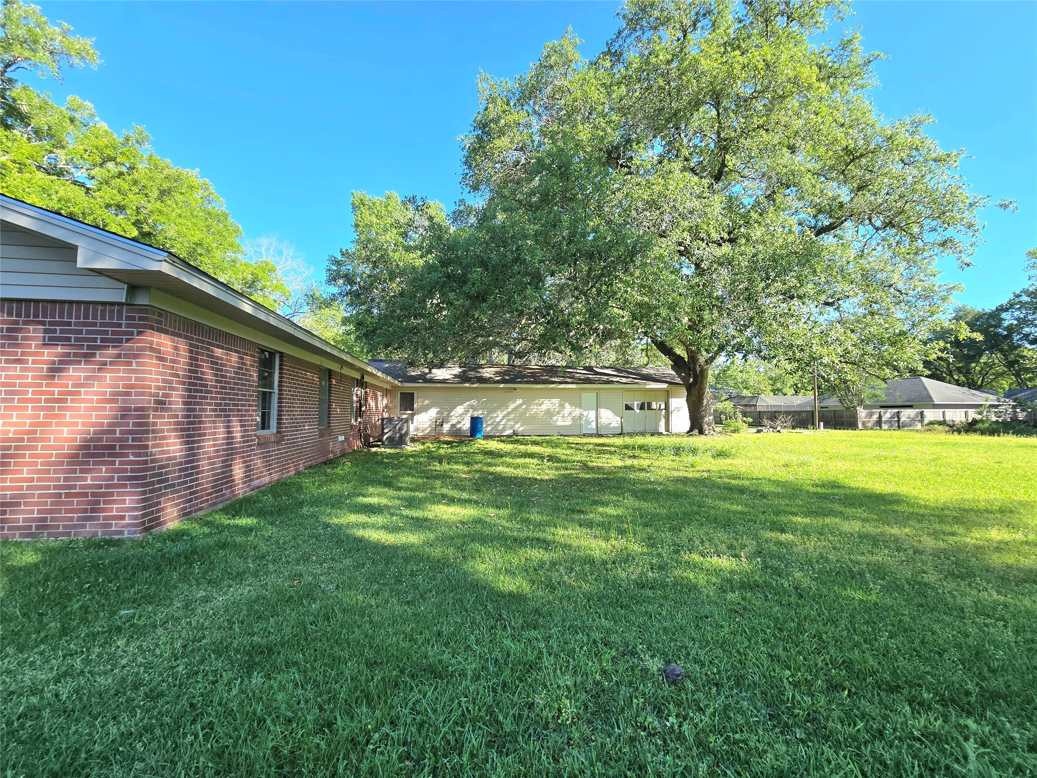 607 South Main Street Dayton, TX 77535 - Photo 33 of 39 a view of backyard with large trees